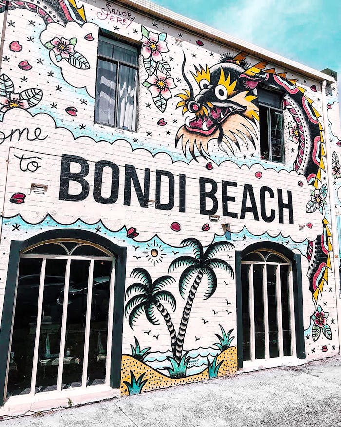 Colorful mural art graces a wall at iconic Bondi Beach in Sydney, showcasing urban creativity.