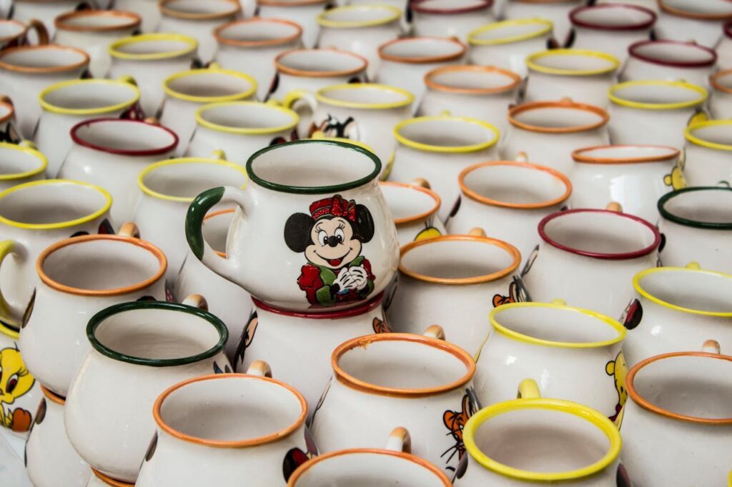 A collection of stacked ceramic mugs with cartoon characters in Kütahya, Türkiye.