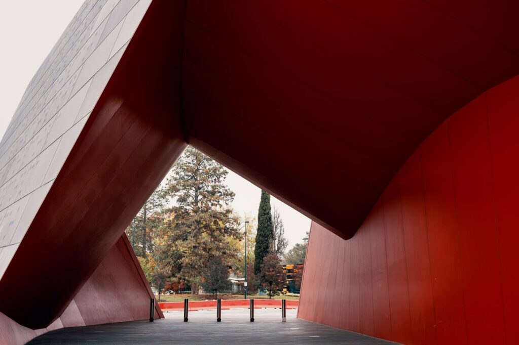 A contemporary architectural design in Canberra showcasing bold red shapes and dynamic structures.